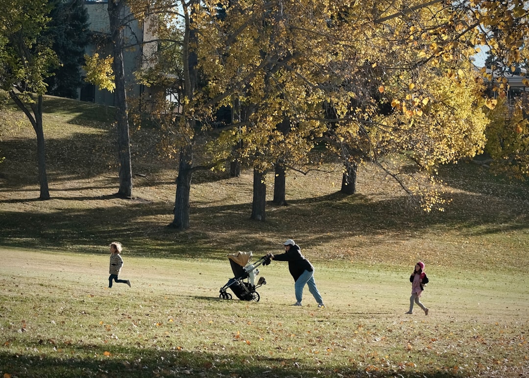 People walking with a stroller in a park