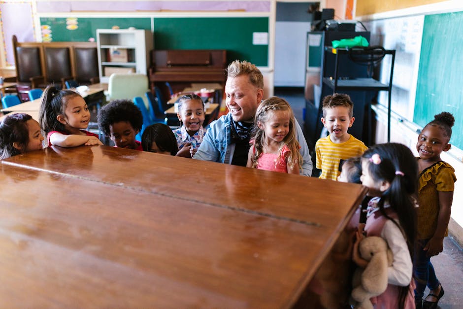 Kindergarten children gathered around a teacher, engaging in cheerful learning activities in a vibrant classroom.